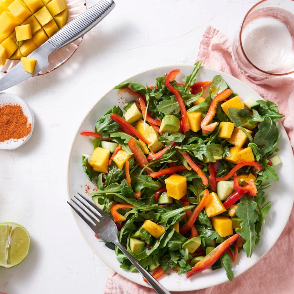 Beautiful arugula salad with mango