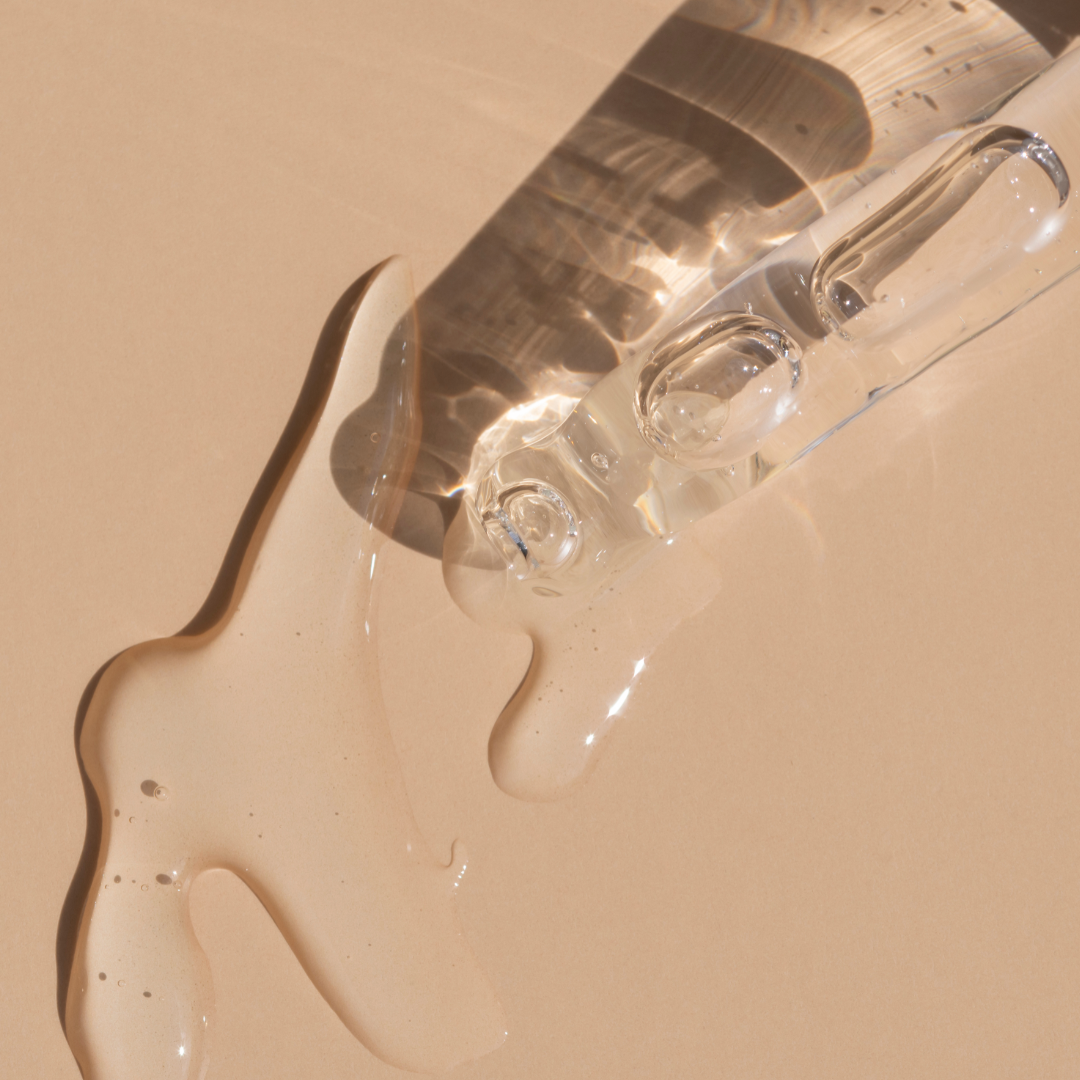 A pipette of retinol serum on a table.