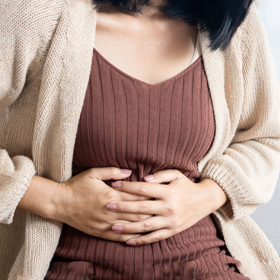 A woman experiencing uncomfortable bloating.