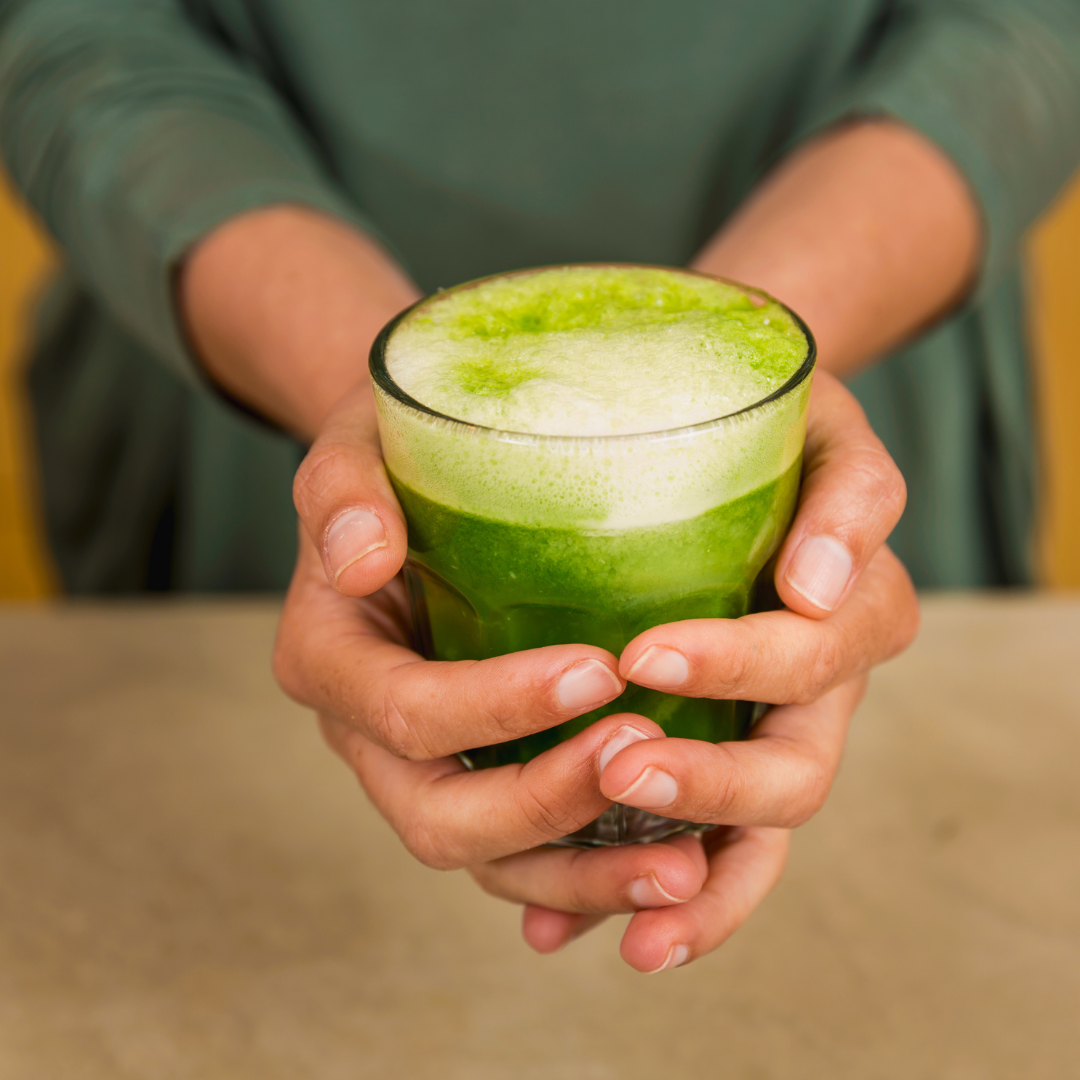 A woman's hands holding detox juice.