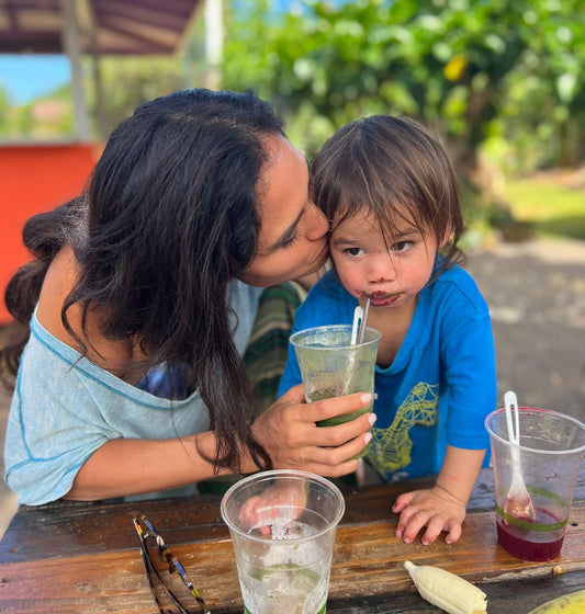 Kimberly drinking a Glowing Green Smoothie with her son Moses