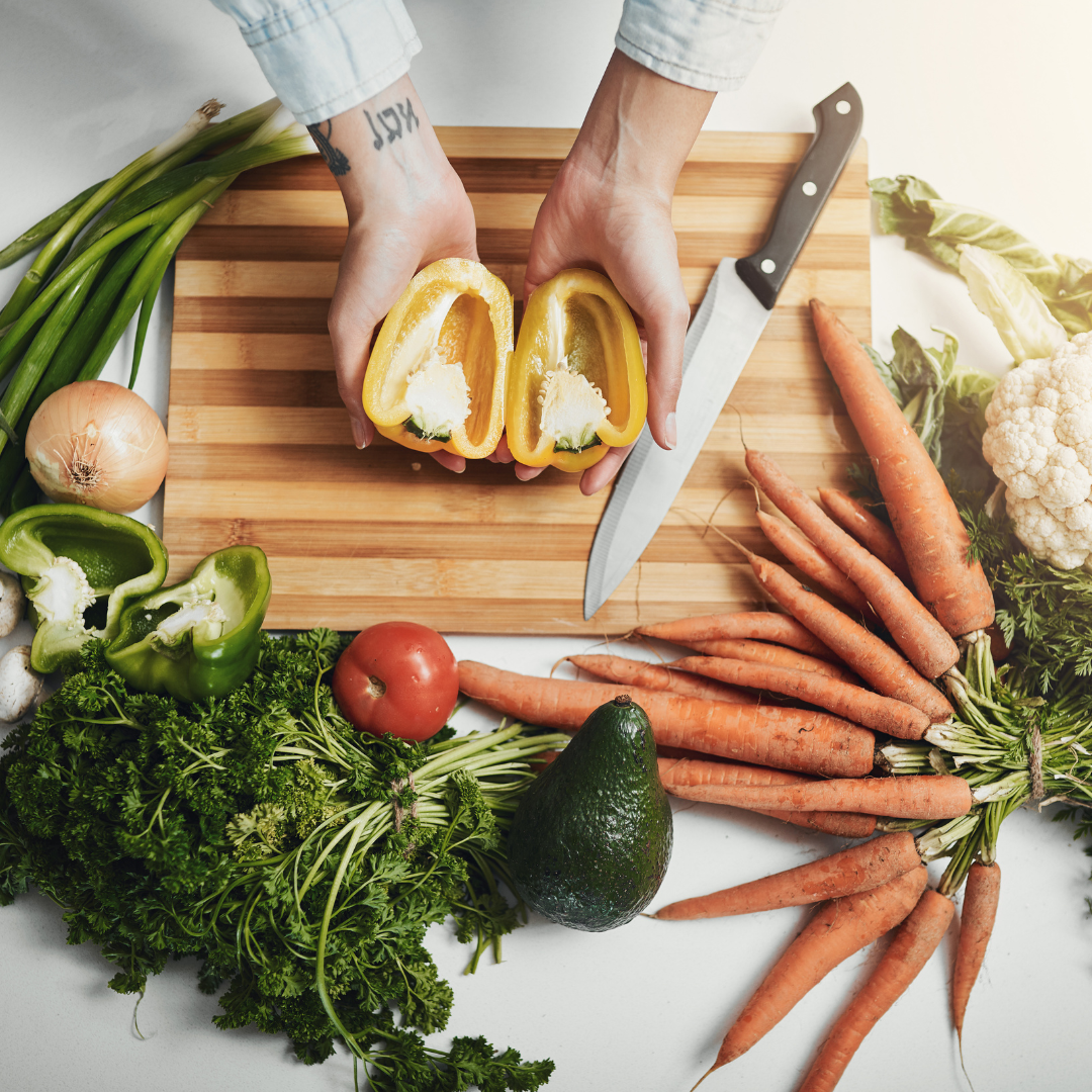 A woman presents a variety of living foods and vegetables