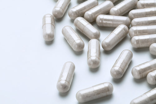 Close up of a pile of Kimbery's enzyme capsules pills.