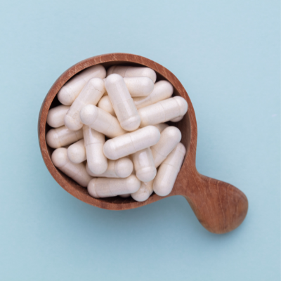 Plant-based capsules in a cup on a blue background.