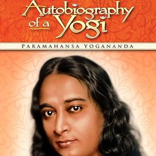 Book cover of 'Autobiography of a Yogi' with Paramahansa Yogananda's portrait on an orange background