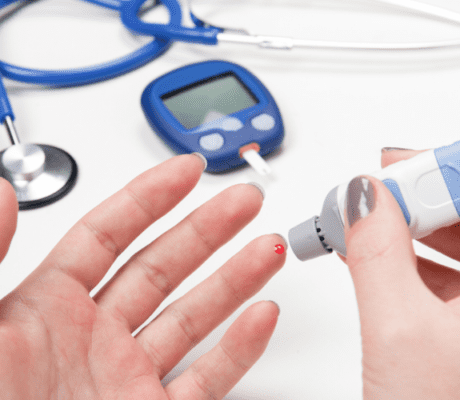 Drop of blood on finger during blood glucose test