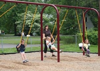 Picture of a woman with kids swinging