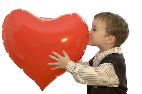 Picture of little boy kissing a heart balloon