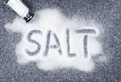 Picture of salt poured on table with the word "salt" 