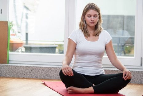 Picture of female sitting on yoga mat
