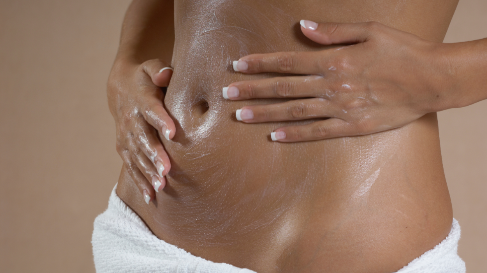 A woman performing an abdominal massage.