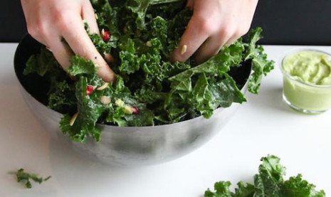 Picture of hands preparing salad in a bowl