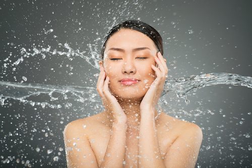 Picture of female washing her face