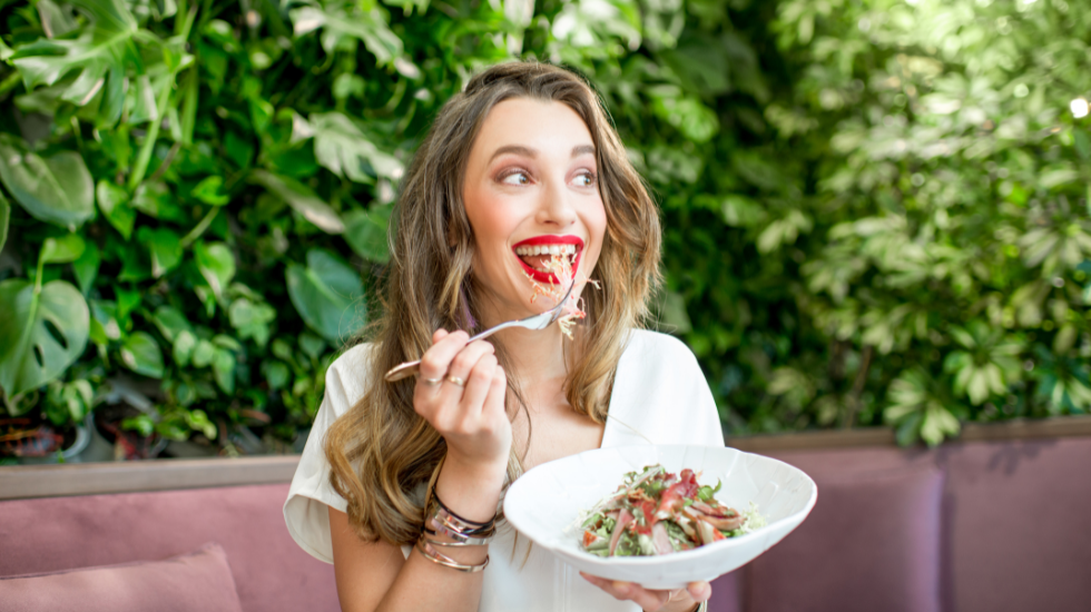 A woman eats a healthy salad