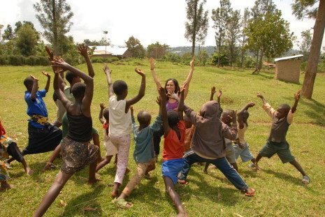 Picture of Kimberly in Rwanda doing yoga with children