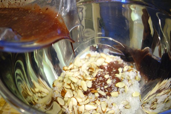 Mix almonds, coconut flakes with blend of Sambazon acai packet, vanilla extract, sea salt, almond milk and coconut nectar. (See exact measurements in recipe below)