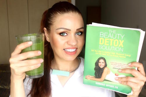 Picture of Renata holding Kimberly's Beauty Detox Solution book and her GGS