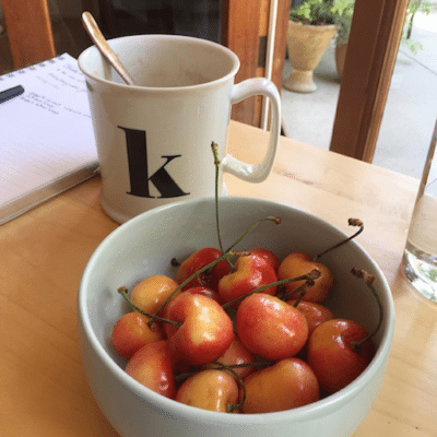 Picture of Kimberly's mug with a K on it and a bowl of cherries. 