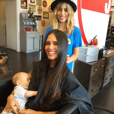 Picture of Kimberly getting her hair done and holding Lil Bub.