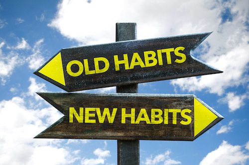 Picture of Old Habits - New Habits signpost with sky background.