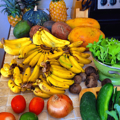 Picture of a huge pile of bananas and other fruits. 