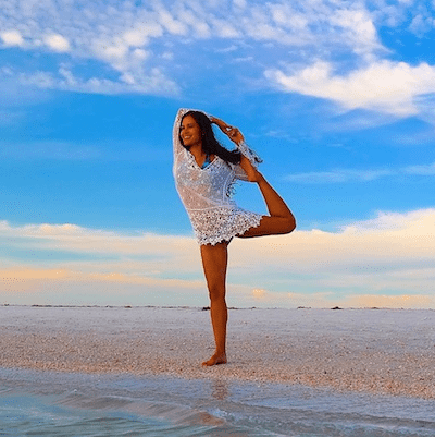 Kimberly doing yoga on the beach.