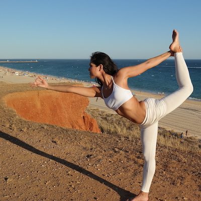 Picture of Kimberly Snyder doing yoga on the beach. 