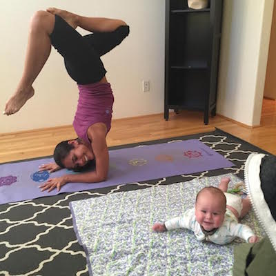 Picture of Kimberly doing yoga with Lil Bub playing on floor mat. 
