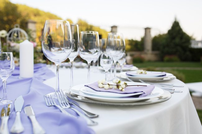 Picture of a wedding table with dishware settings. 