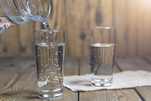 Glasses Of Water On A Wooden Table