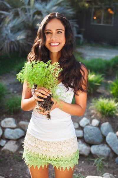 Picture of Kimberly holding some herbs.