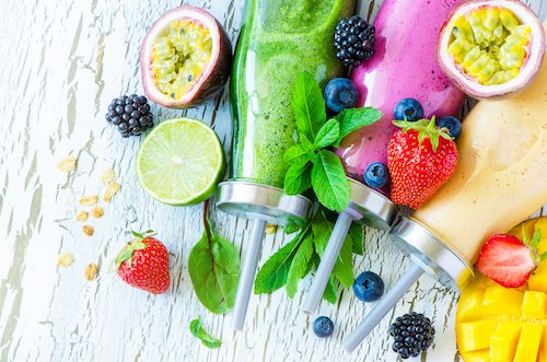 Berry and fruit smoothie in bottles healthy summer detox yogurt drink diet or vegan food concept fresh vitamins mango lime