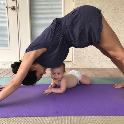 Picture of Kimberly doing yoga with Lil Bub nearby. 
