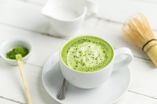 Green tea matcha latte cup with accessories. This latte is a delicious way to enjoy the energy boost & healthy benefits of matcha. Matcha is a powder of green tea leaves packed with antioxidants.