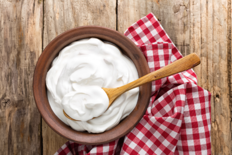 A bowl of yogurt on a rustic wooden table