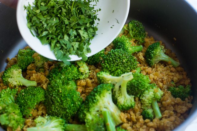 Image of broccoli and cilantro added to pan