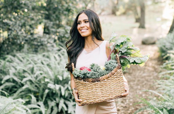 Kimberly Snyder holding a basket of fresh produce. 