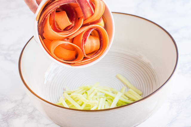 Adding carrots to the bowl