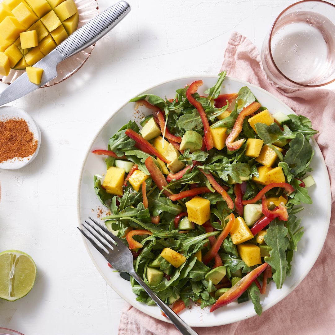 Beautiful arugula salad with mango