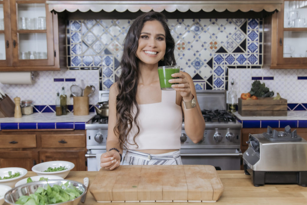 Kim in her kitchen after preparing a glowing green smoothie.