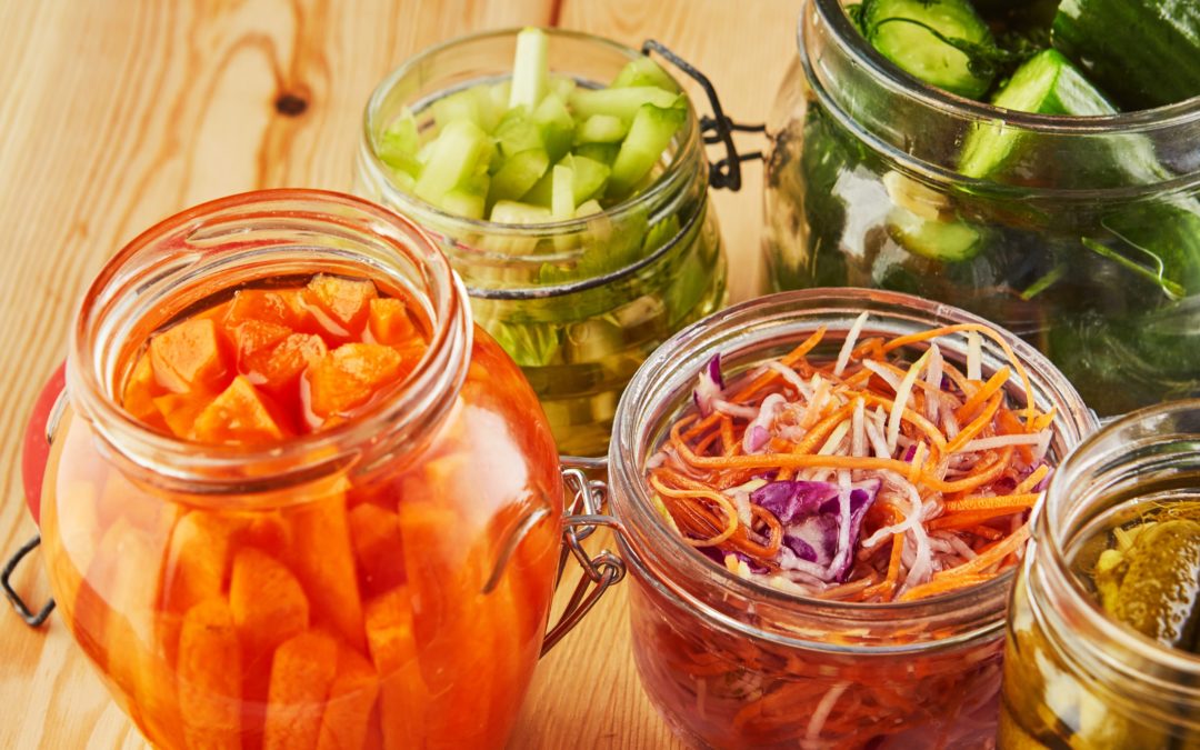 A colorful presentation of healthy fermented foods on a table.