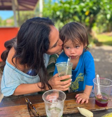 Kimberly drinking a Glowing Green Smoothie with her son Moses