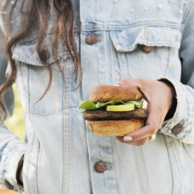 Kimberly holding a burger outside
