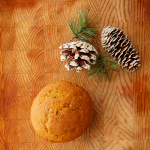 A pumpkin pie muffin on a festive background.