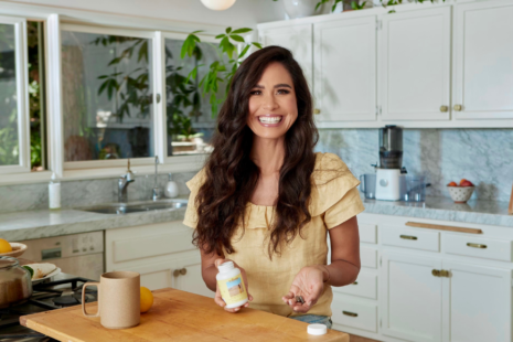 Kimberly Snyder in her kitchen with Feel Good SBO Probiotics+